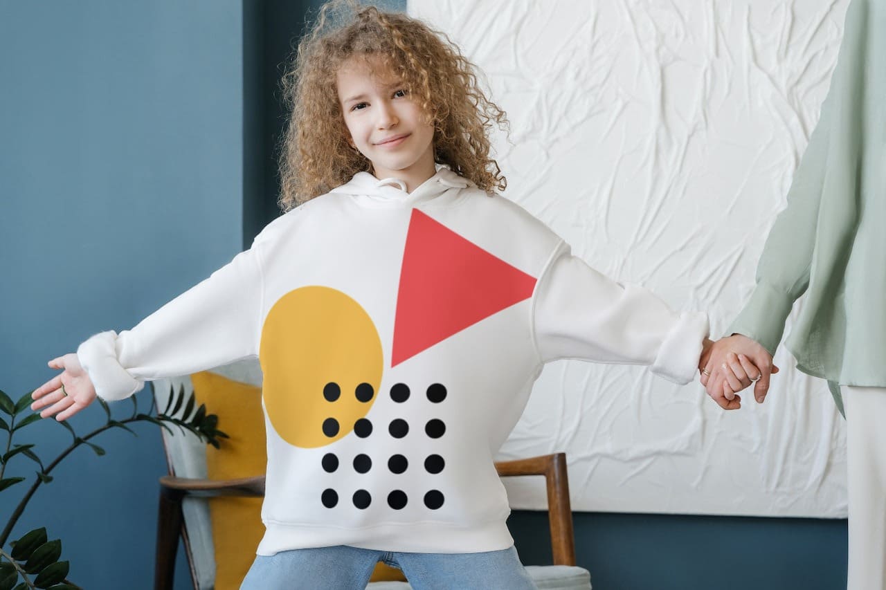 a girl with a hoodie with a printed pattern